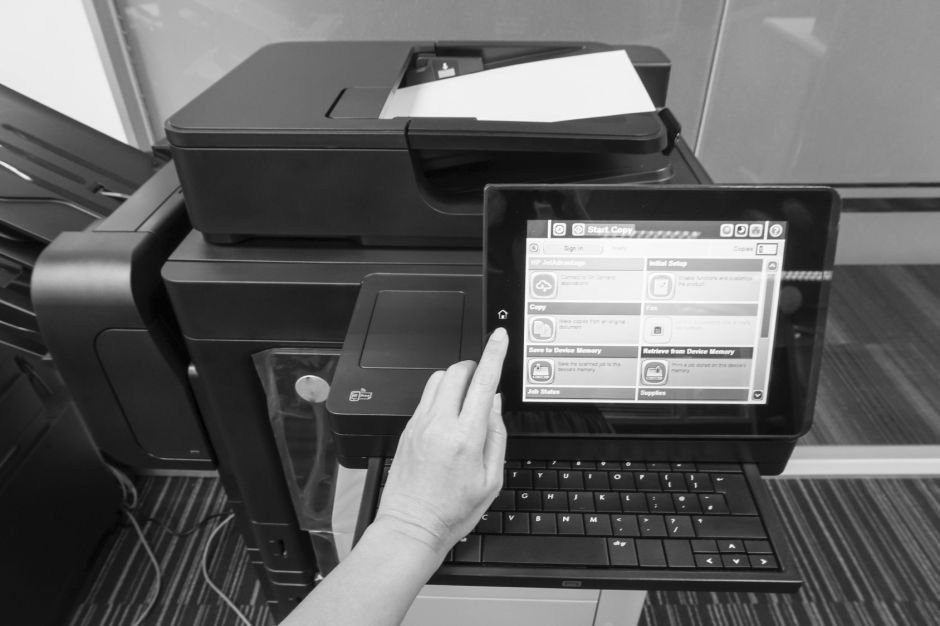 jummie – stock.adobe.com woman press on printer touchscreen to scan documents