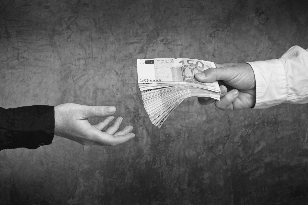 Bits and Splits – stock.adobe.com Money Loan. Bank officer loaning stack of euro banknotes money.