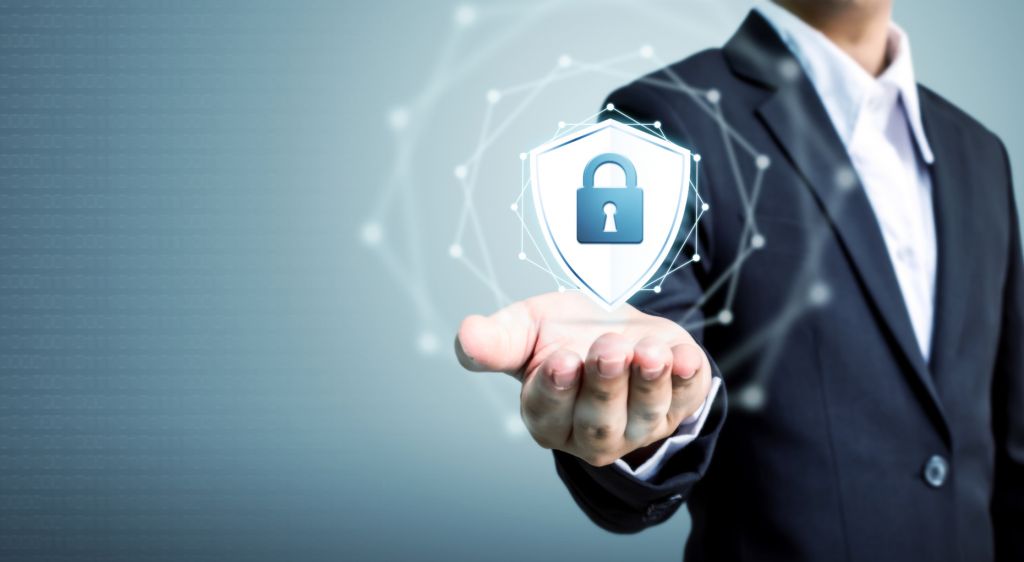 Monster Ztudio – stock.adobe.com Protection network security computer and safe your data concept, Businessman holding shield protect icon